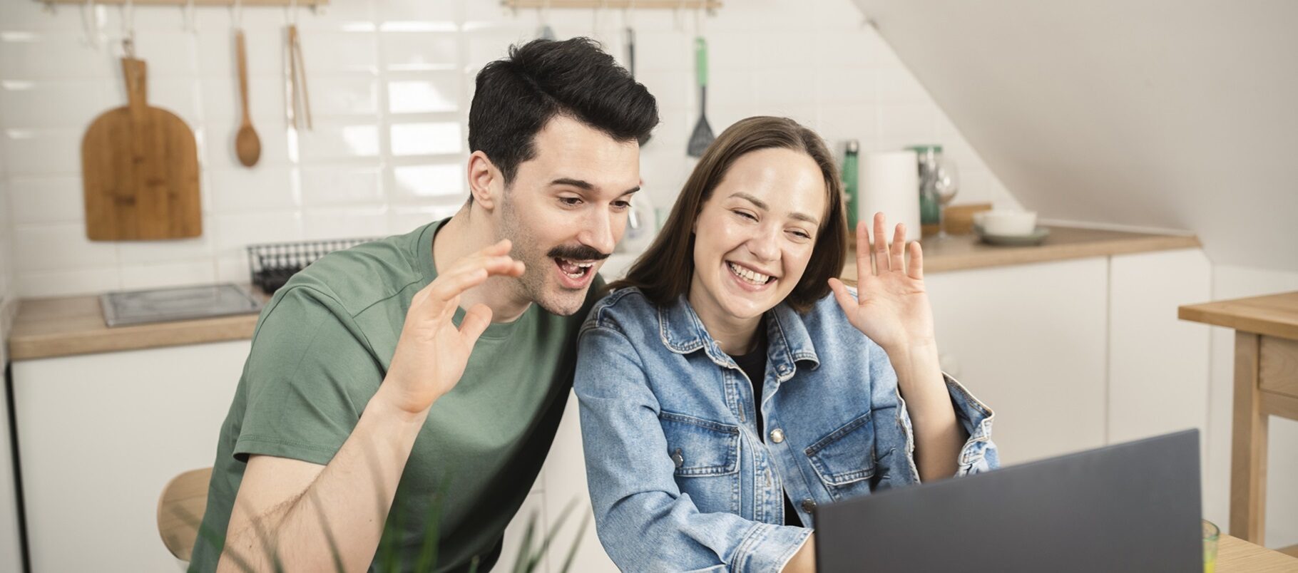 Happy couple working online together at their home office and making a video call